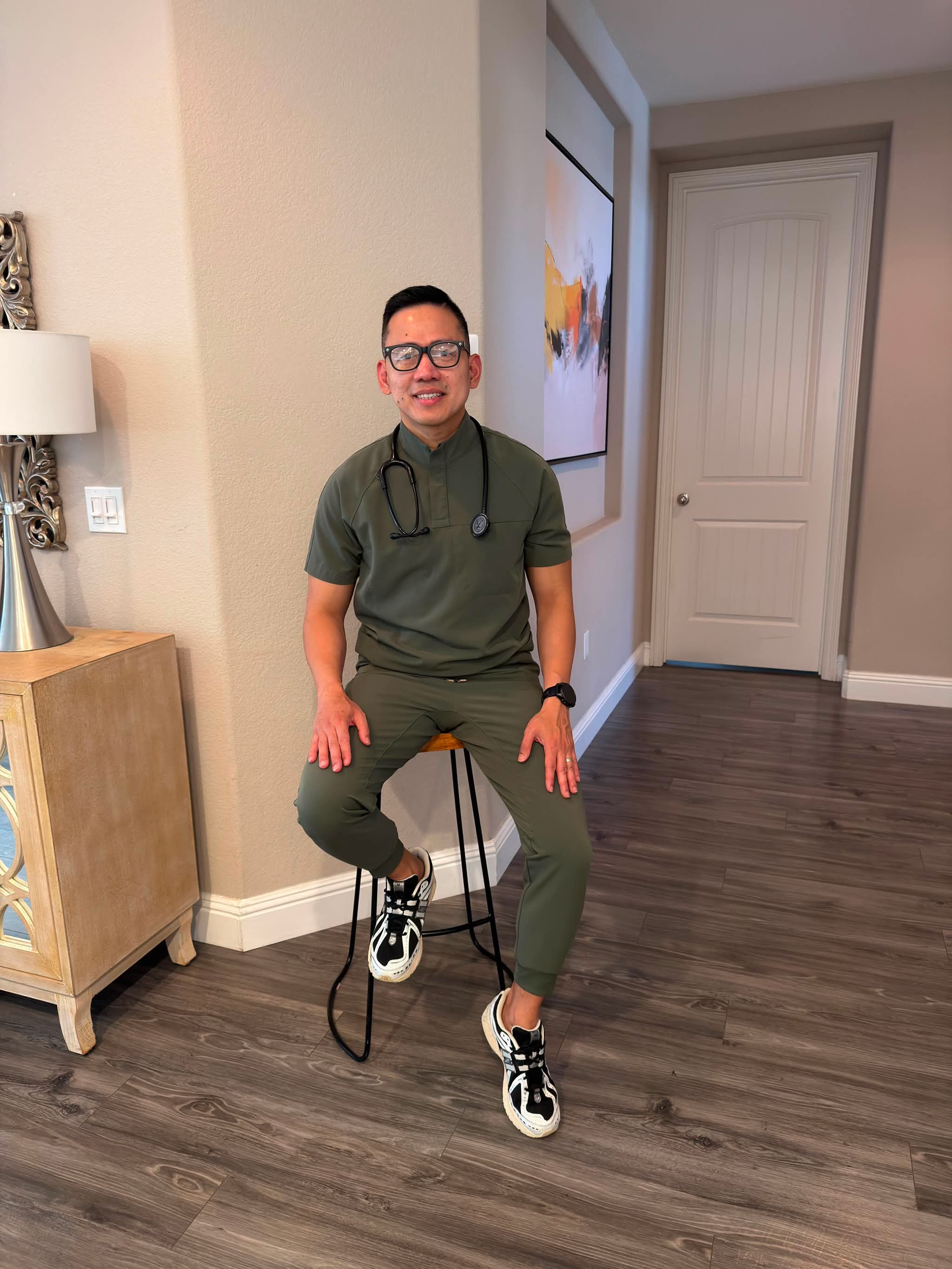 James Bonifacio, MSN, RN, CMSRN, in scrubs with a stethoscope